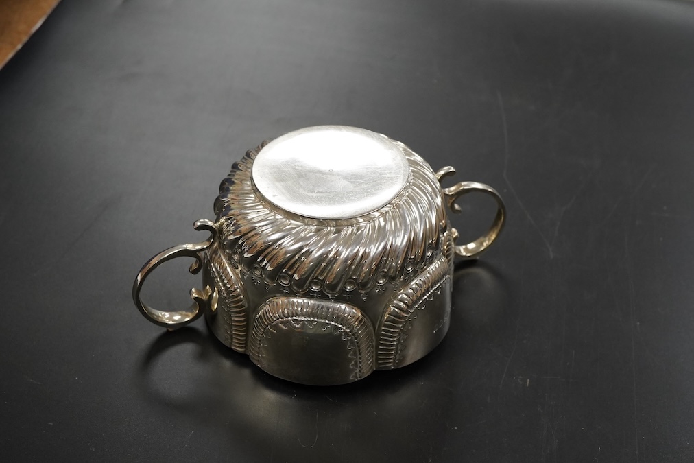 A late Victorian silver twin handled porringer in ealry 18th century style hanlded to handle 17cm., weight approx. 6.48ozt